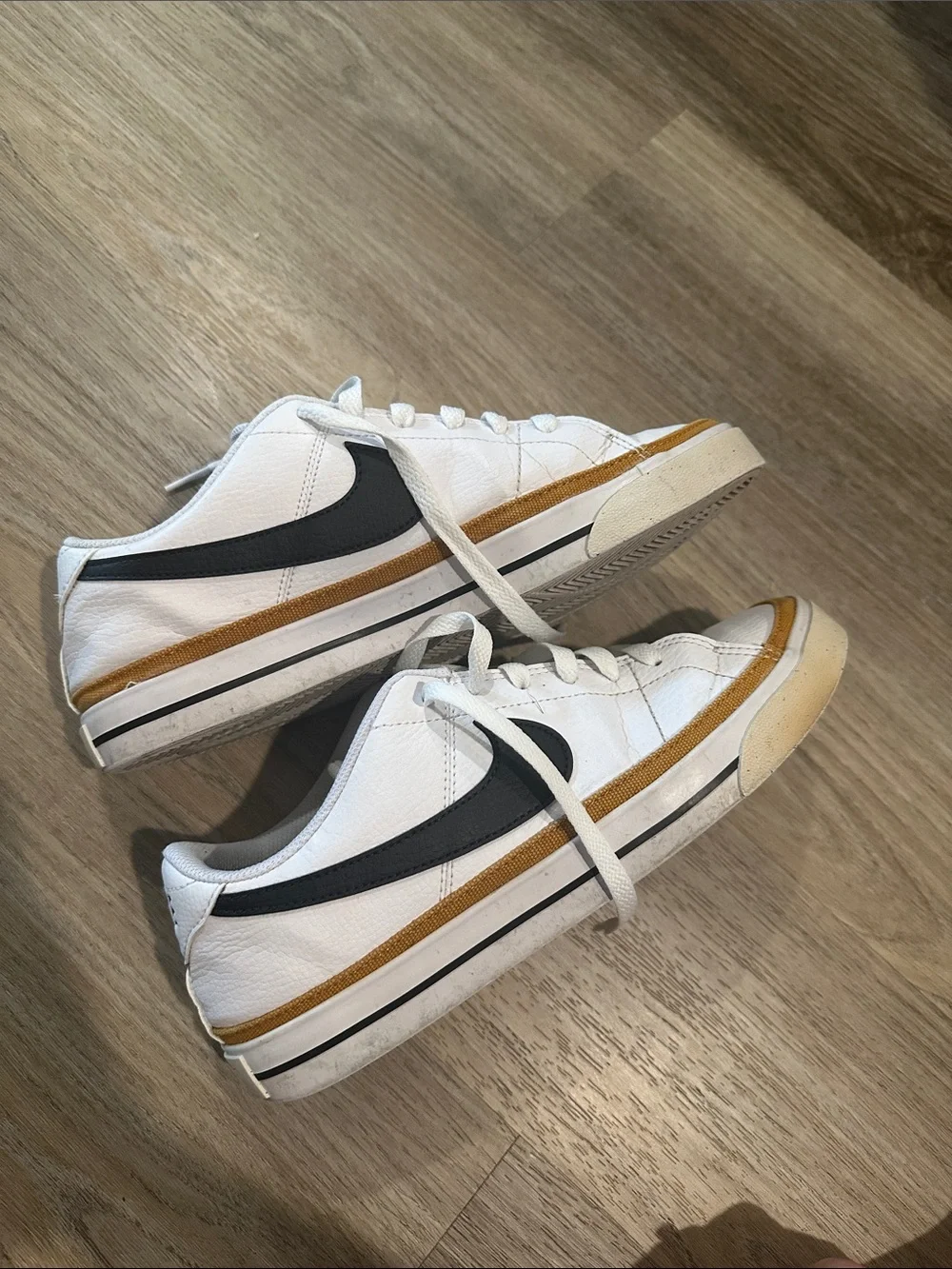 Nike White Low-Top Sneakers with Black Swoosh and Tan Trim court legacy